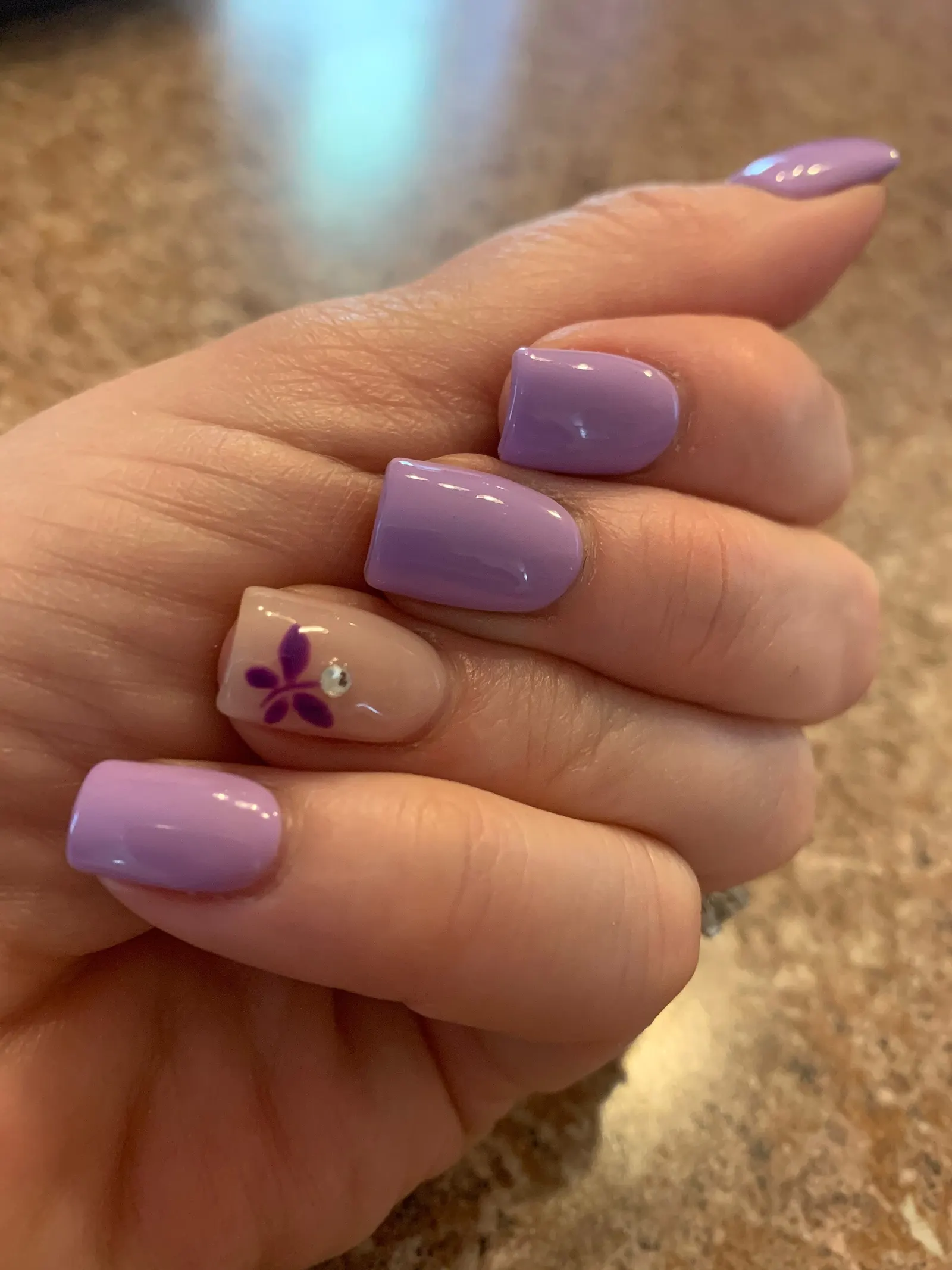 Lavender gel nails with a small crystal accent